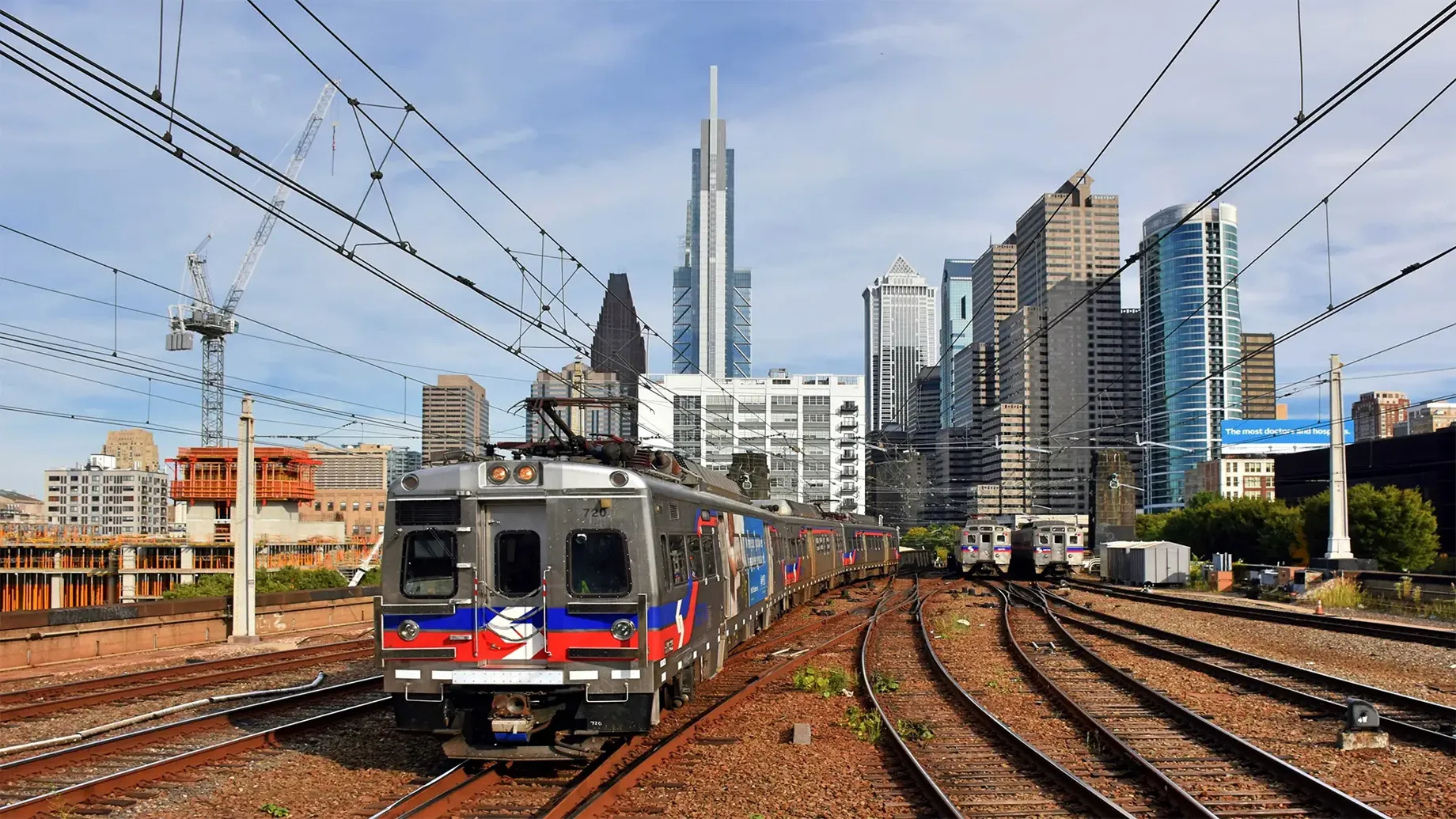 A train on the railway tracks with a skyline in the distance