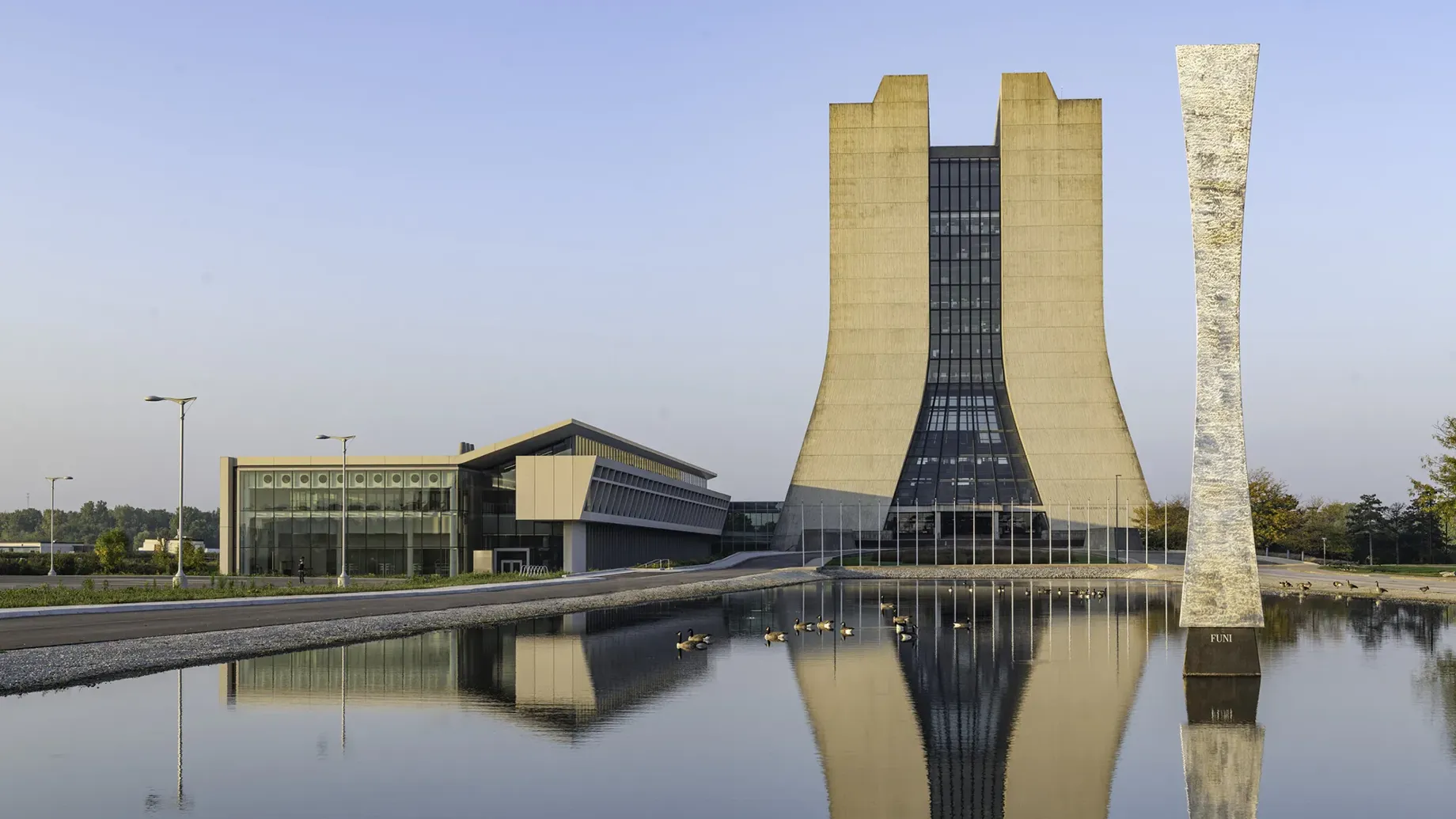 A building with a tower in the middle of a body of water.