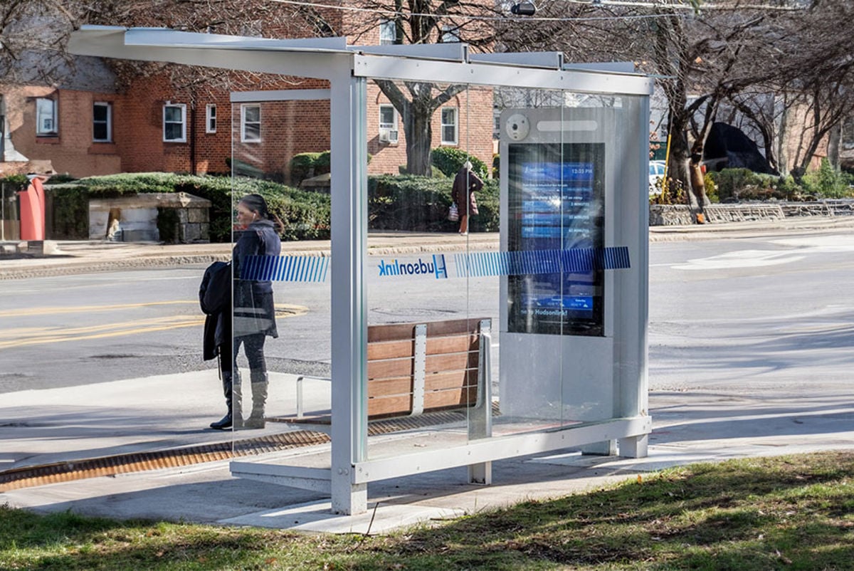 Woman standing at a bus stop