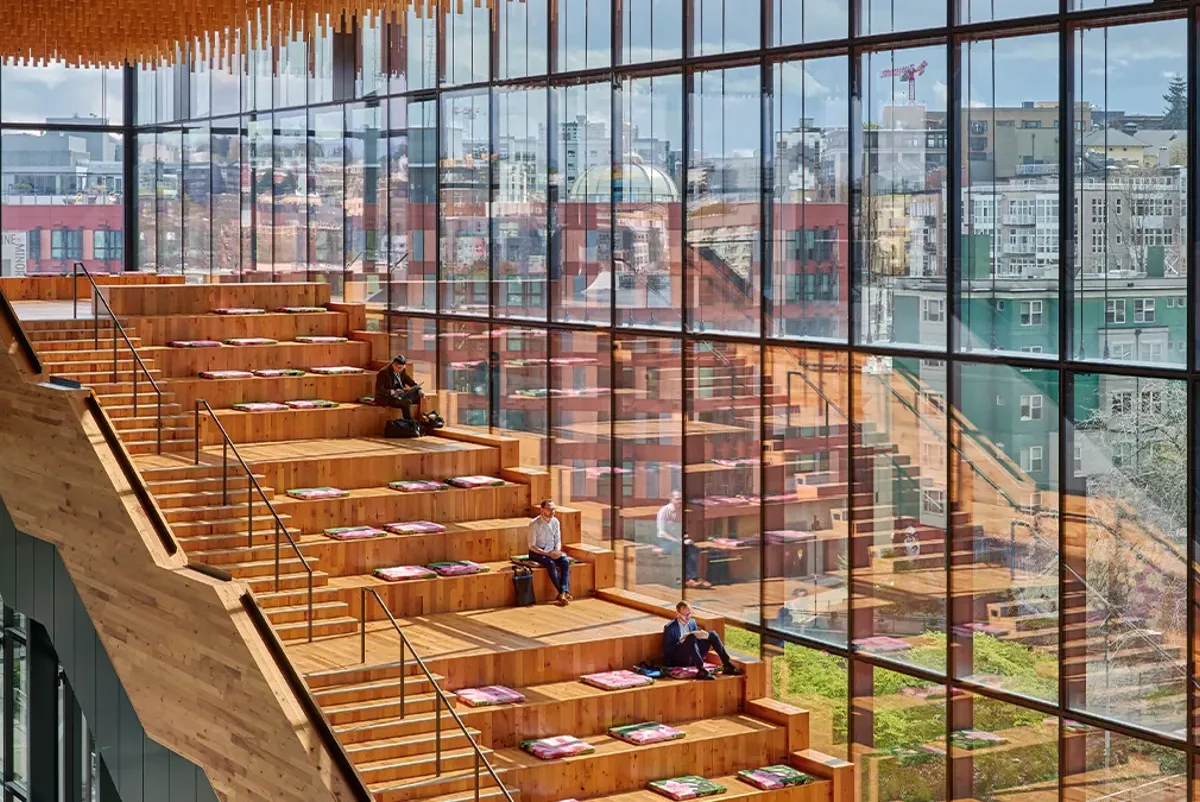 A group of people sitting on the stairs of a building.