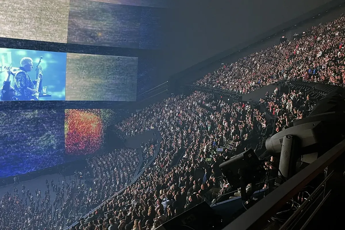 A large crowd of people watching a stage.