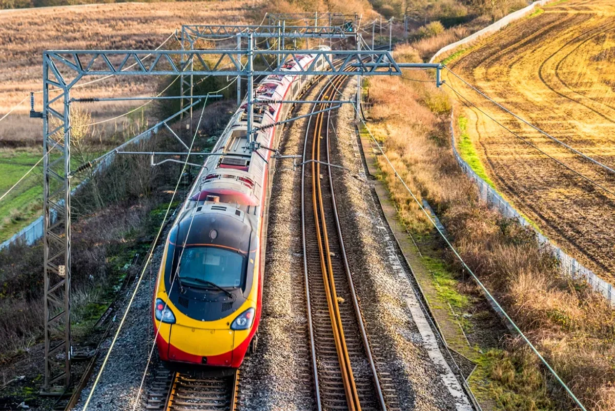 Train moving along a track in the countryside