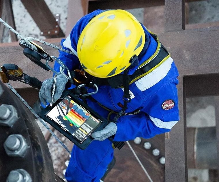 Man using an iPad to undertake maintenance