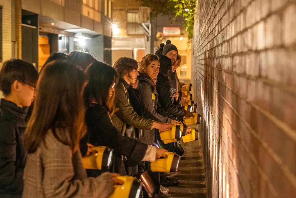 People exploring the streets at night to understand lighting considerations