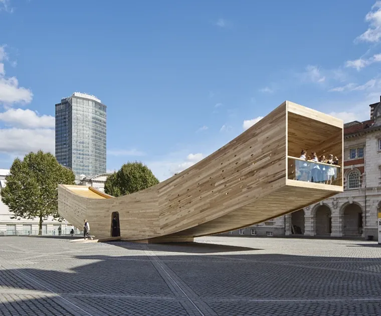 A cross-laminated timber structure shaped like a smile